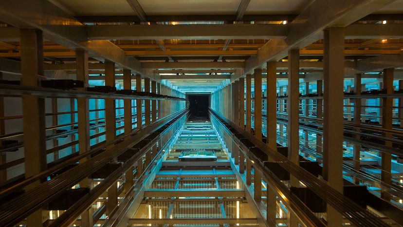 Looking up at the inside of a modern elevator shaft. Futuristic effect.