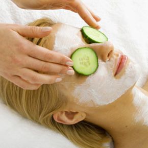 Woman with facial and cucumbers.
