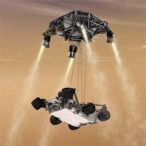 由于它的尺寸，好奇号不能用安全气囊辅助着陆。相反，火星科学实验室使用了图中所示的天空起重机着陆系统，该系统能够将一个更大的火星车送入火星表面。＂border=