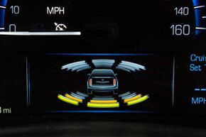 Cadillac's latest safety technologies include graphics on the gauge cluster that indicate when an object has been detected in the path of the vehicle.