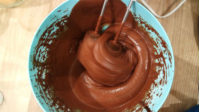 The batter for a chocolate cake swirls in a mixing bowl. Every ingredient -- as well as the mixing method -- contributes to the taste and texture of a cake.  Babina Wisnevson/EyeEm/Getty Images