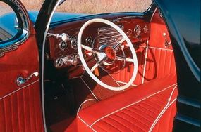 The interior of the Calori Coupe was impeccably finished with roll-and-pleat upholstery and contrasting white trim.