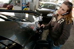 A customer pumps gas into her car at a gas station in San Jose, Calif.