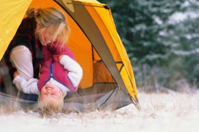 Mother and daughter camping in the snow