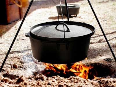 Traditional Dutch Oven cooking or Chuckwagon cooking over an open flame.