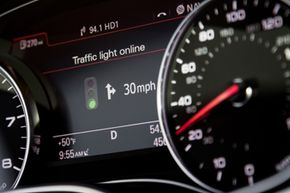 Traffic light information is displayed on Audi's Driver Information System (DIS) located in the vehicle's central instrument cluster.