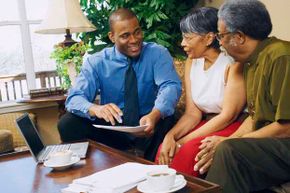 Couple with businessman discussing finances