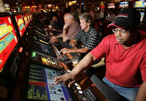 Players play video poker in a casino. See more casino pictures.