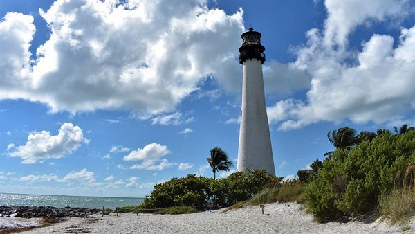 Beacon guiding along blue-sand coastal nature.