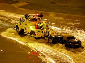 The most important part to car towing safety is, of course, proper driving skills. Here, a tow truck pulls a car from the flooded outbound lan of the Dan Ryan Expressway in Chicago, Ill.