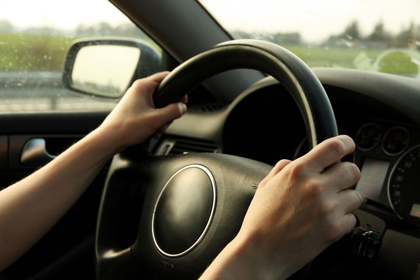 Man holding wheel of car