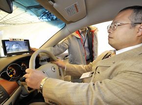 A Nissan engineer demonstrates his company's driver alert system in Tokyo in 2008. See more car safety pictures.