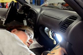 Auto tech Becky McInnis reinstalls an airbag after changing the inflator module on a 2003 Toyota Tundra.