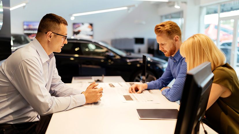 Car salesperson and clients