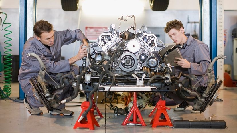 mechanics working on engine