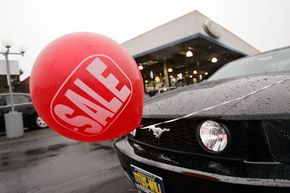 A "sale" balloon advertises a special price on a Mustang at a Ford dealership in Tacoma, Wash.