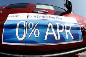 Zero percent interest rate availability is draped on the side of an unsold 2008 Denali at a GMC Truck dealership in Littleton, Colo.