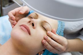 Woman receiving face treatment.