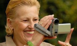 middle-aged woman filming with a handycam