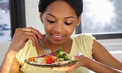 Woman eating salad. 