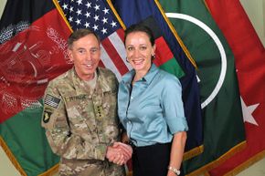A July 13, 2011 photograph of Gen. Davis Petraeus shaking hands with his biographer and paramour, Paula Broadwell. 