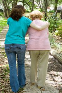 Two women walking in a park. 