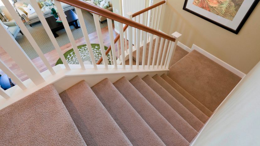 View down interior carpeted stairs in a modern American home.