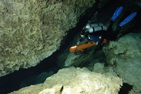 Stiff fins help cave divers move through the water easier, while dry suits keep them warmer.