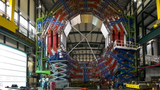 How does CERN synchronize timing devices?