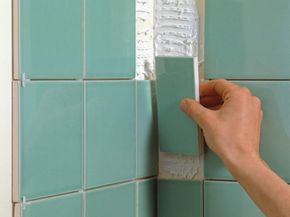 man installing ceramic tile
