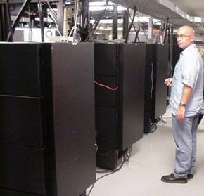 Drew McKeen standing next to the SGI Onyx machines