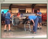 Watch the team working in the garage to prepare the car for the race.