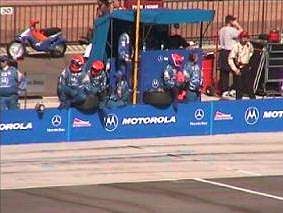 During the race, the Motorola PacWest team waits for driver Mark Blundell to pull into the pit.