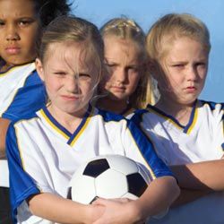 determined girls with soccer ball