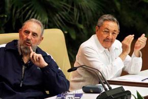 Fidel Castro (left) makes a point during the Cuba's 6th Party Congress session in 2011; his brother Raul looks on.