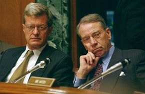 Senate Finance Committee Chairman Max Baucus (left) and Sen. Charles E. Grassley (R., Iowa) listen intently during a discussion of charitable tax deductions.