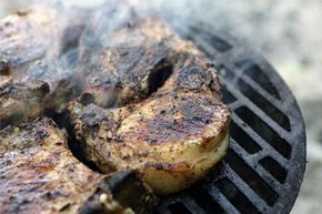 charred meat being cooked on the grill