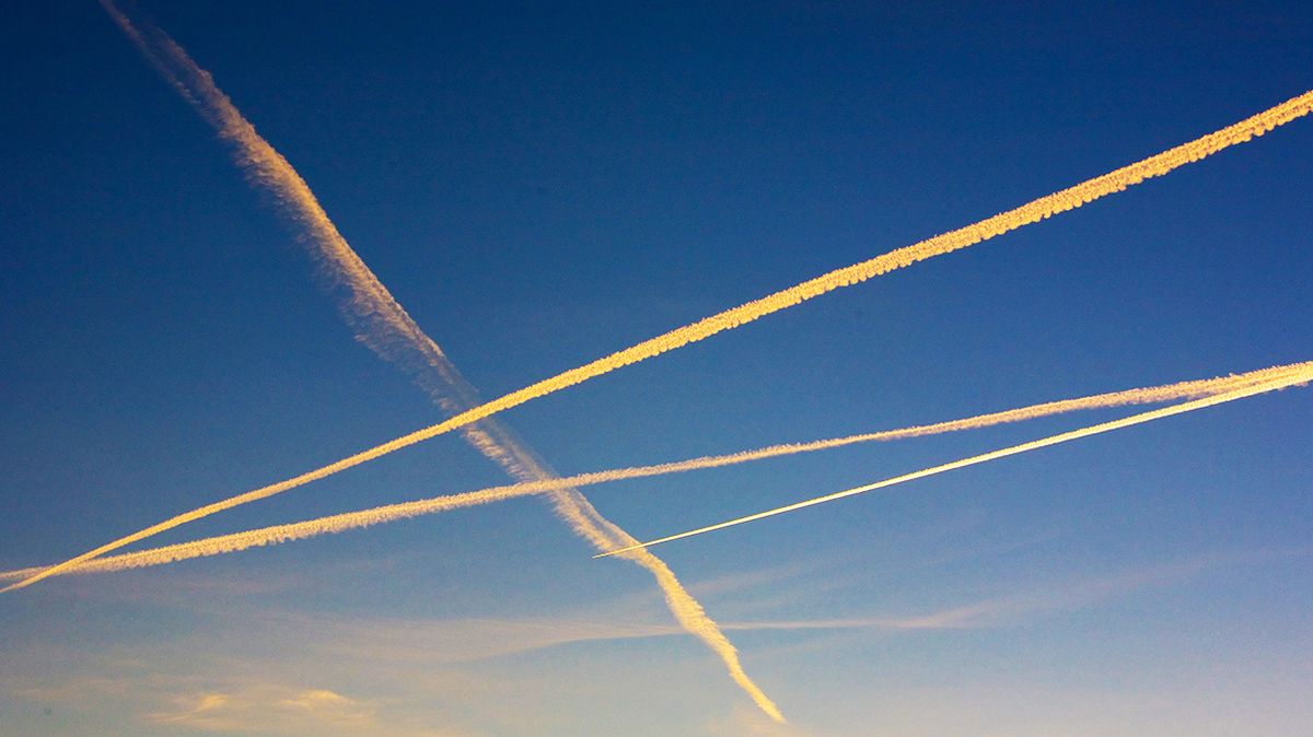 Rocket trails move sideways through the sky