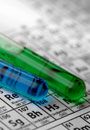 Filled test tubes on backdrop of periodic table of the elements.