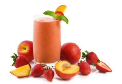 a glass of strawberry peach smoothie