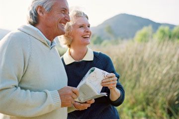 Active seniors outdoors, smiling joyfully.