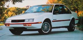 A white, 1989 Chevrolet Beretta.