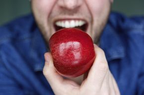 Man about to bite apple