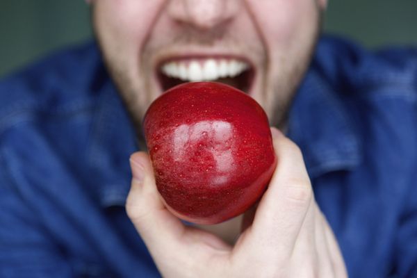 Man about to bite apple