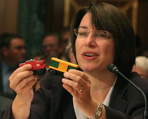 The numerous toy recalls attracted the attention of Congressional leaders. Here U.S. Senator Amy Klobuchar holds a toy with lead paint at a Senate subcommittee meeting about toy safety.