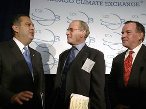Dr. Richard Sandor (C) speaks with the U.S. Secretary of Energy and Chicago's mayor shortly after the CCX held its first auction for emission allowances.
