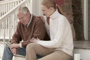 dad and daughter sit on the steps