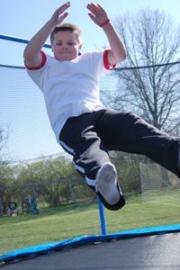 boy jumping on a trampoline