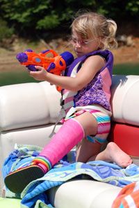 girl with a broken leg and a squirt gun