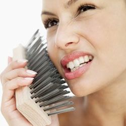 woman taking a wire brush to her face